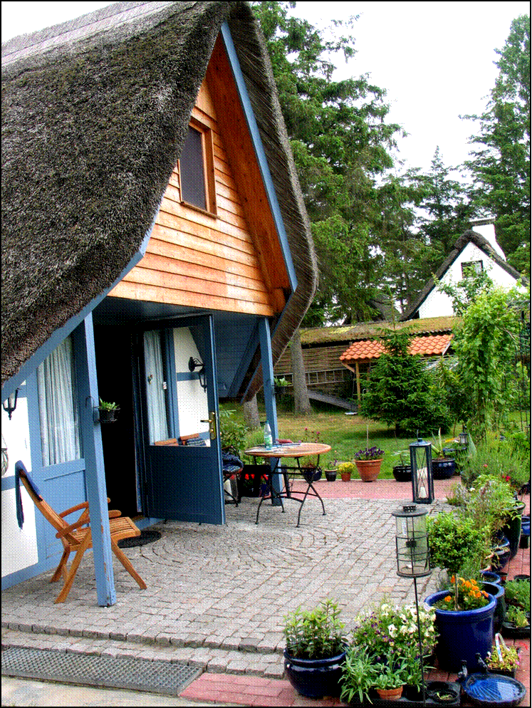 Veranda aus grauem Granit mit diversen blauen Pflanztpfen umrandet